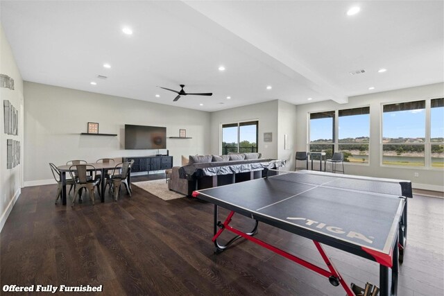 rec room with beam ceiling, ceiling fan, and dark hardwood / wood-style floors