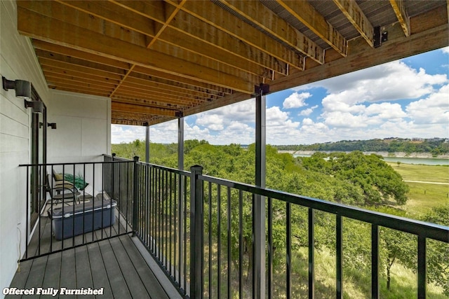 wooden deck featuring a water view