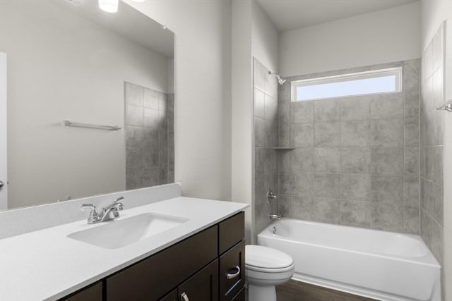 bathroom featuring toilet, shower / washtub combination, and vanity