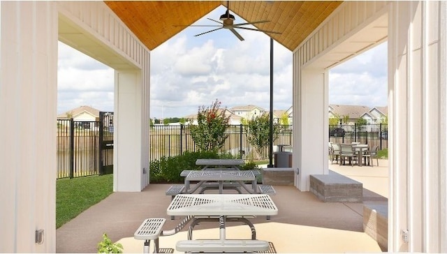 view of patio featuring outdoor dining space, ceiling fan, and fence