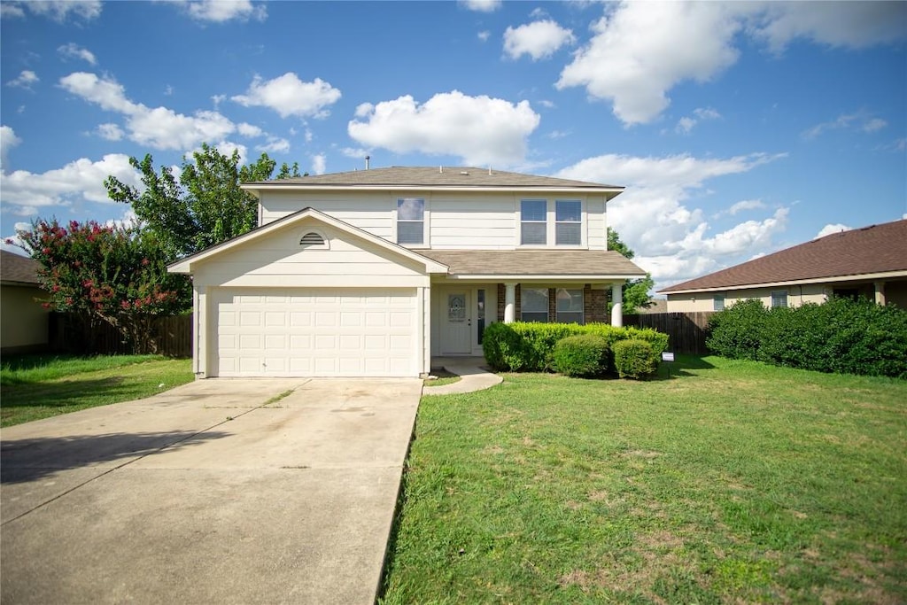 view of front property with a garage and a front yard