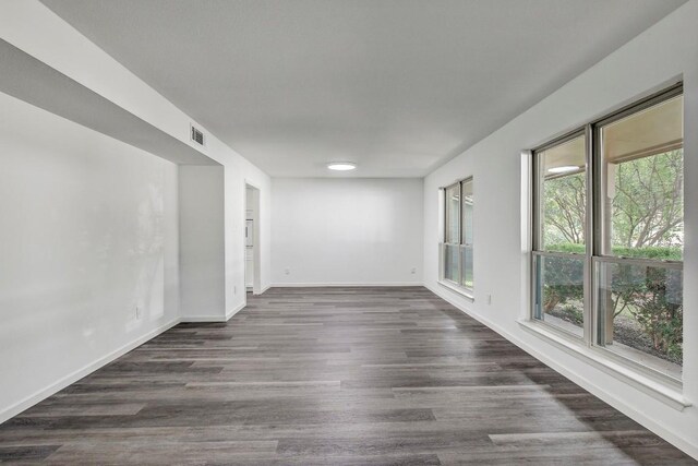 empty room with dark hardwood / wood-style flooring