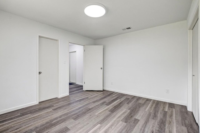 1504 Colony Creek Dr, Austin, TX 78758 - unfurnished bedroom featuring wood finished floors and baseboards