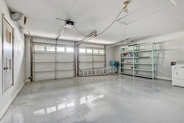 garage with washer / dryer and a garage door opener