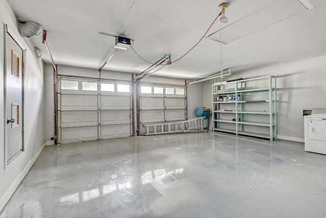 garage featuring baseboards, washer / clothes dryer, and a garage door opener