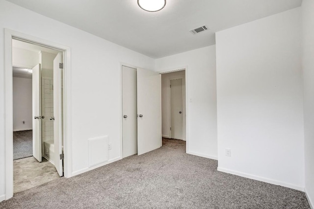 unfurnished bedroom featuring carpet floors, baseboards, and visible vents