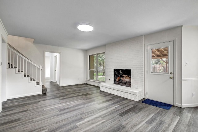 1504 Colony Creek Dr, Austin, TX 78758 - unfurnished living room featuring wood finished floors, a fireplace, stairs, and baseboards