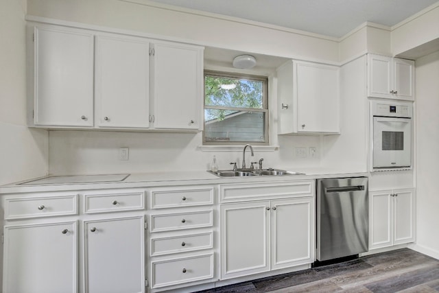 kitchen with white cabinetry, oven, and stainless steel dishwasher