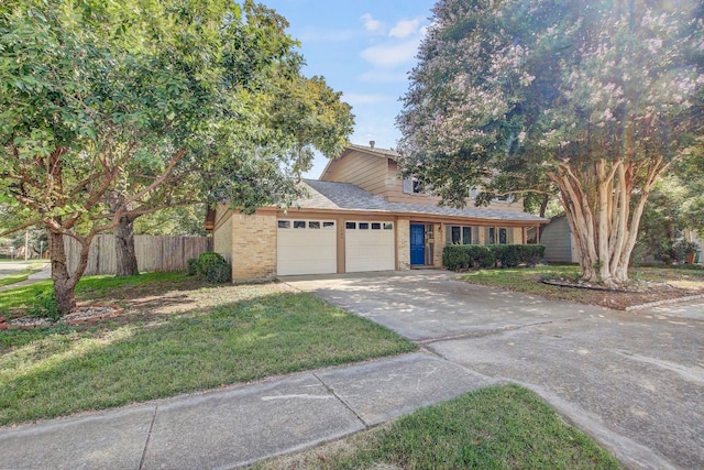 view of front of house with a front yard and a garage