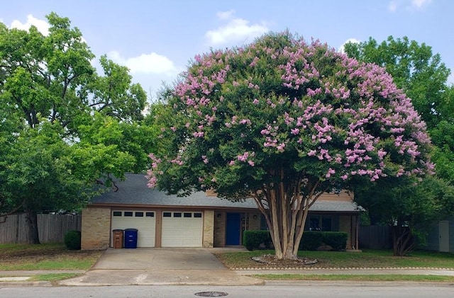 1504 Colony Creek Dr, Austin, TX 78758 - view of front of house with a garage, concrete driveway, and brick siding