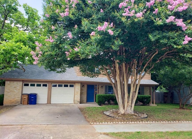 1504 Colony Creek Dr, Austin, TX 78758 - view of front of house with concrete driveway, a garage, and brick siding