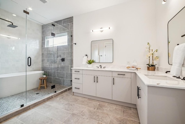 bathroom with vanity and independent shower and bath