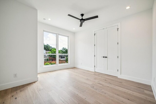 unfurnished bedroom featuring ceiling fan and light hardwood / wood-style flooring