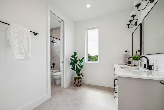 bathroom with baseboards, vanity, toilet, and bathing tub / shower combination