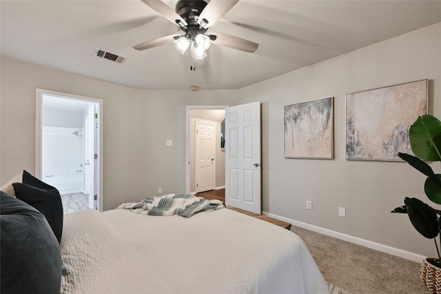 bedroom with visible vents, a ceiling fan, ensuite bath, carpet, and baseboards