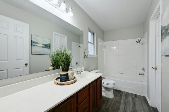 full bathroom featuring vanity, toilet, wood finished floors, and bathtub / shower combination