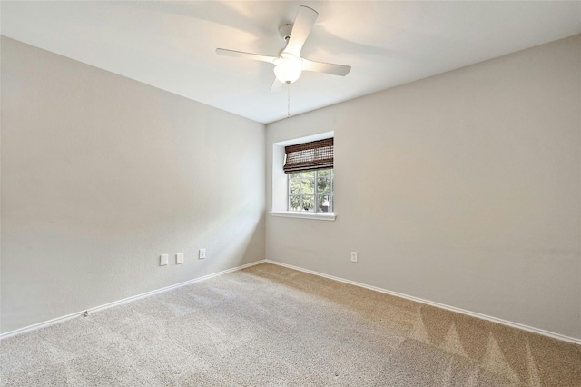 spare room featuring baseboards, carpet floors, and ceiling fan