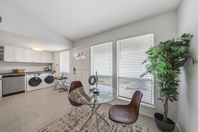 dining room featuring lofted ceiling and washing machine and dryer