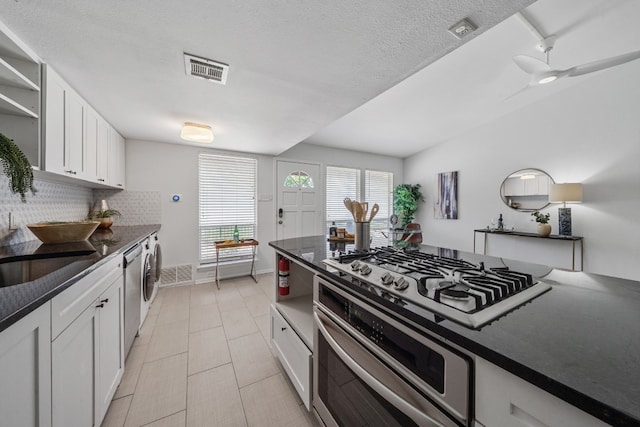 kitchen with white cabinets, tasteful backsplash, oven, and gas cooktop