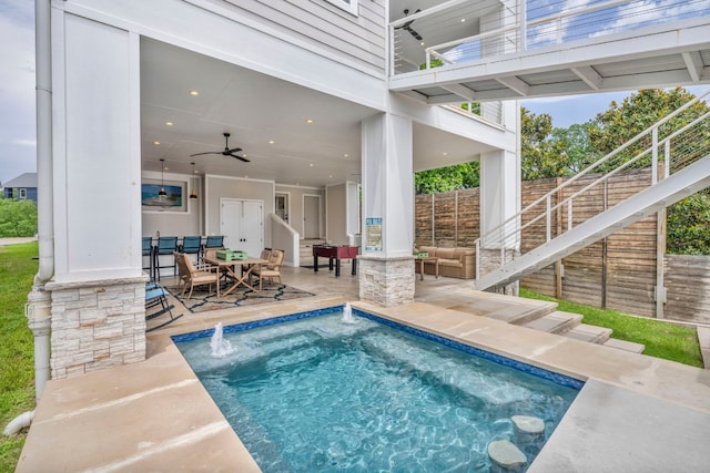 view of pool featuring a patio area, pool water feature, and ceiling fan