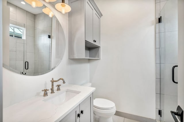 bathroom with tile floors, a shower with shower door, toilet, and vanity