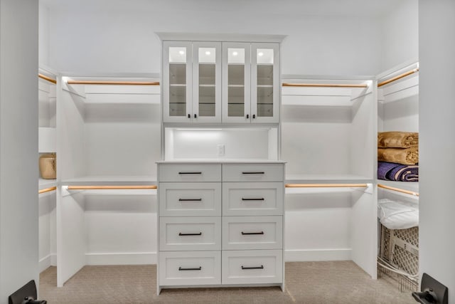 walk in closet featuring carpet flooring