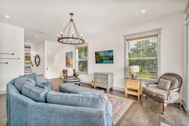 living room with an inviting chandelier and hardwood / wood-style floors