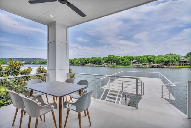 view of patio with ceiling fan and a water view