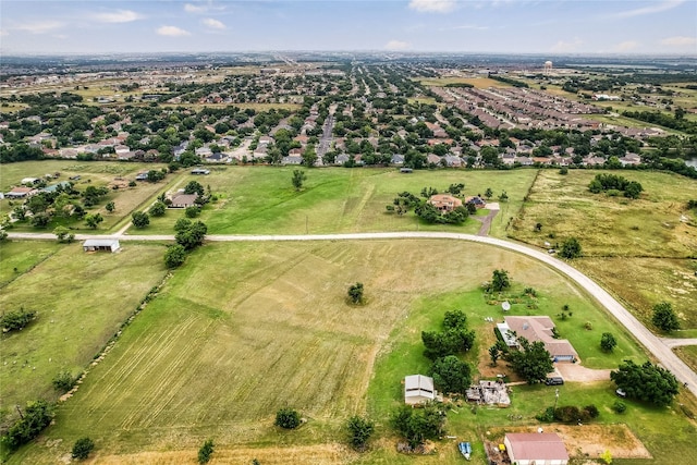 birds eye view of property with a rural view