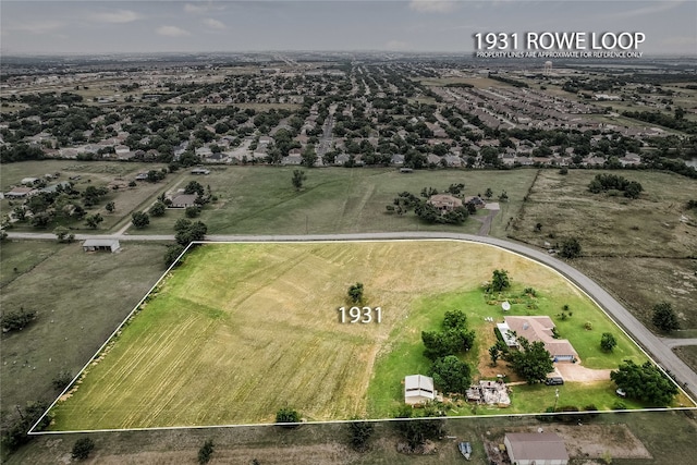 birds eye view of property with a rural view