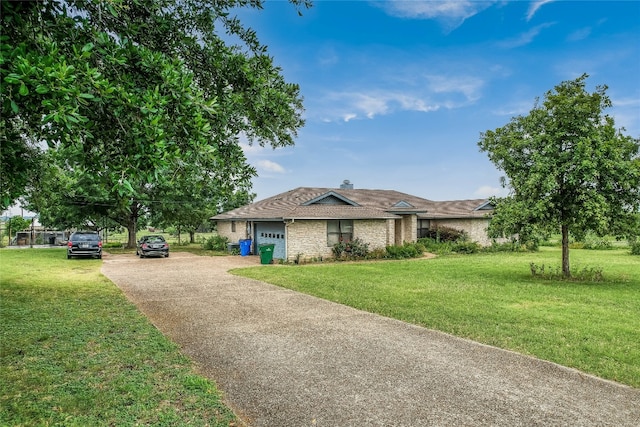 ranch-style home featuring a garage and a front yard