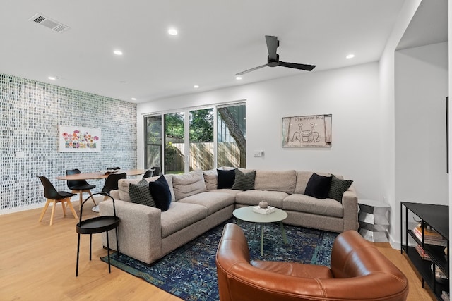 living room with light wood-type flooring and ceiling fan