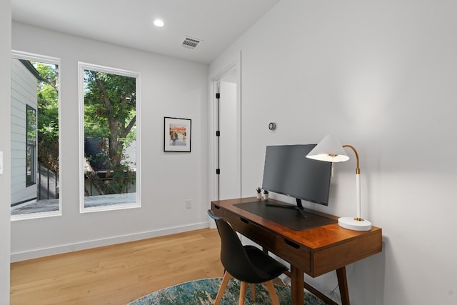 home office with wood-type flooring