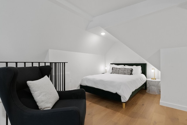 bedroom with light hardwood / wood-style flooring and lofted ceiling