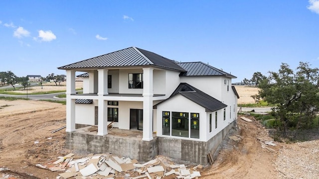 rear view of property with a balcony