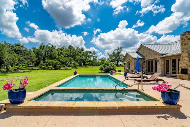 view of pool with french doors, a yard, and a patio