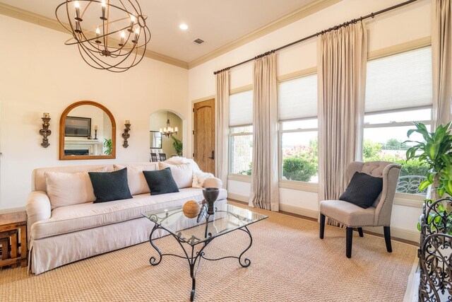 living room with a notable chandelier and ornamental molding