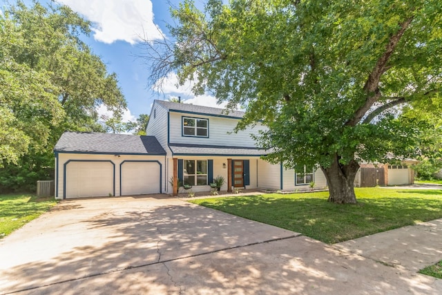 view of front of house featuring a garage and a front lawn