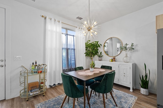 dining room with a notable chandelier and hardwood / wood-style floors