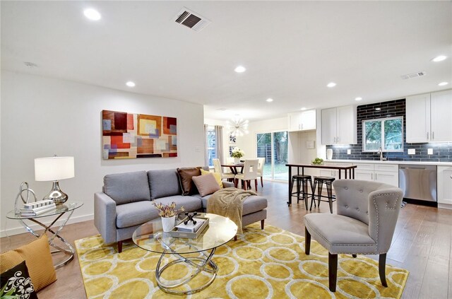 living room with a healthy amount of sunlight and light hardwood / wood-style floors