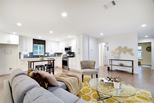 living room featuring hardwood / wood-style floors and a wealth of natural light