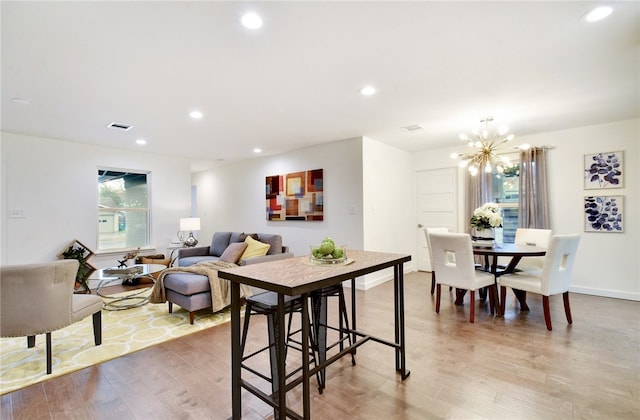 dining area with a chandelier and hardwood / wood-style floors