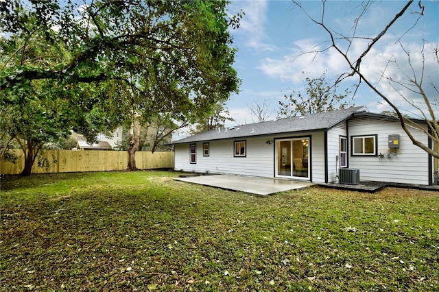 back of house with cooling unit, a patio area, and a yard