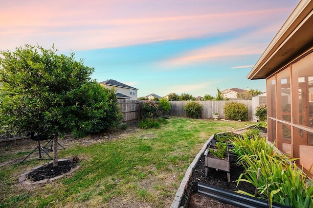 view of yard at dusk