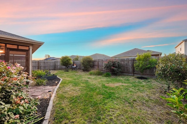 view of yard at dusk