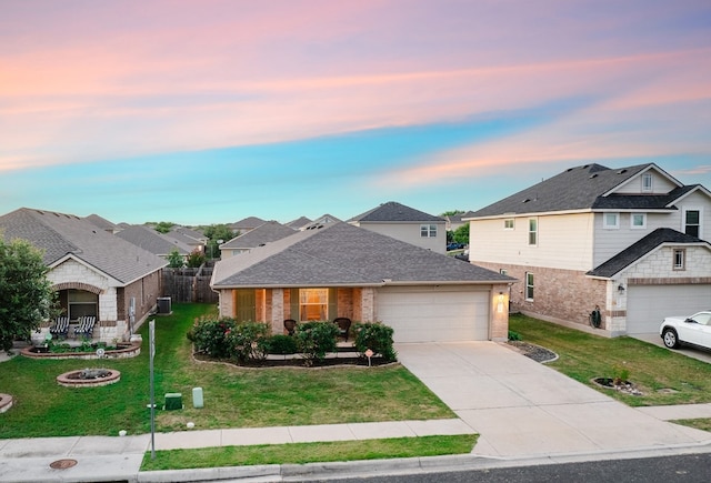 view of front of house with a garage and a yard