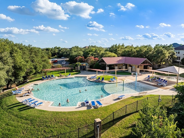 view of pool featuring a yard and a patio