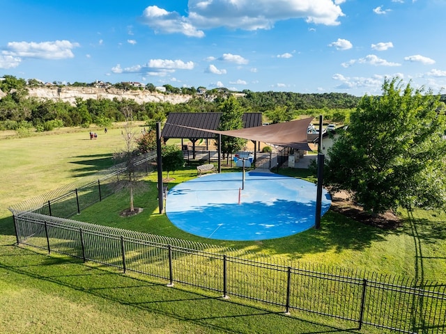 view of pool featuring basketball court and a lawn