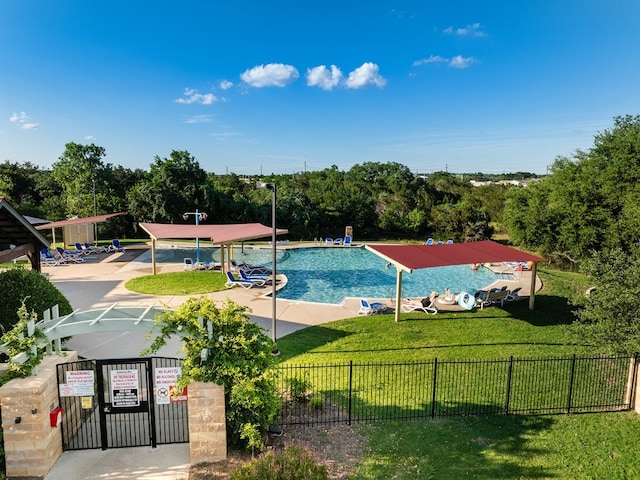 view of pool featuring a lawn