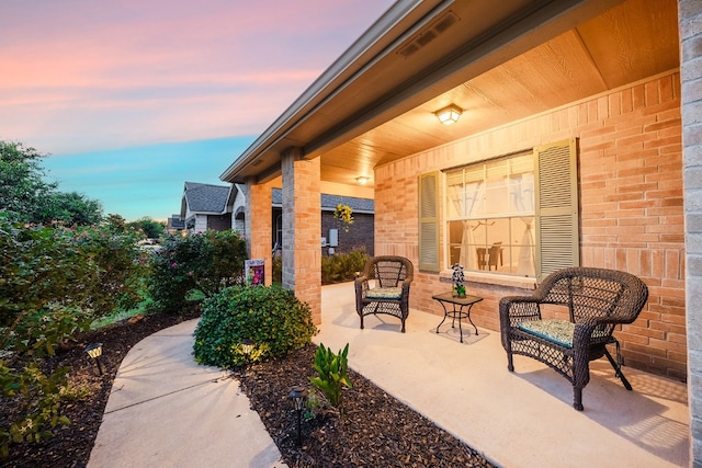 patio terrace at dusk with covered porch